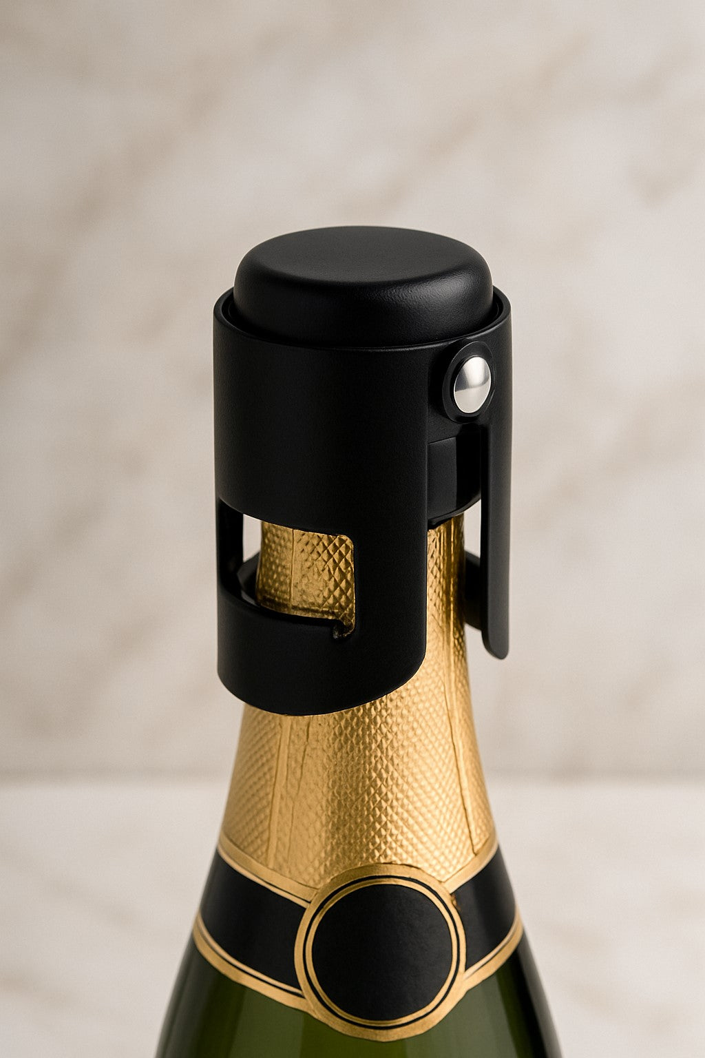 A black and rose gold champagne cork stopper fitted on a champagne bottle with a visible brand label.